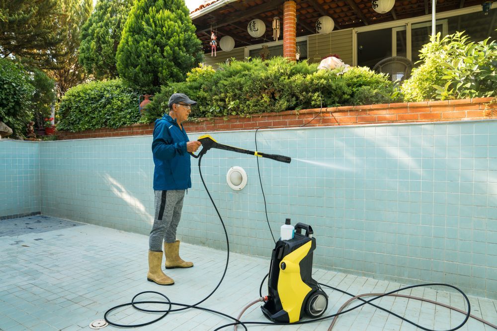 Person Power Washing an Empty Pool — Port Douglas Pool Shop in Craiglie, QLD
