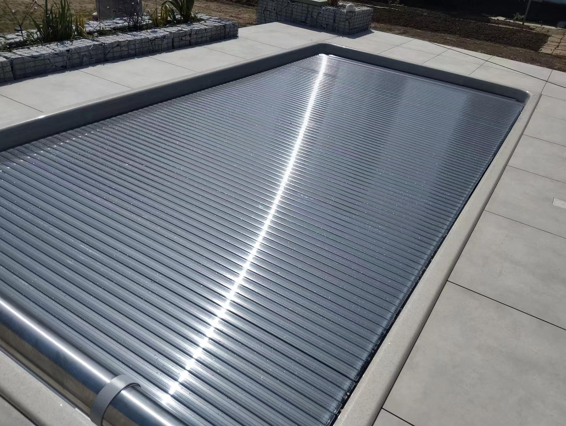 Gray Pool Cover Partially Covering a Rectangular Pool — Port Douglas Pool Shop in Craiglie, QLD