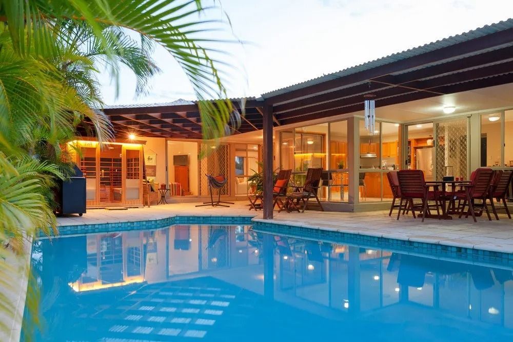 Swimming Pool and Outdoor Living Area With a Covered Patio — Port Douglas Pool Shop in Craiglie, QLD