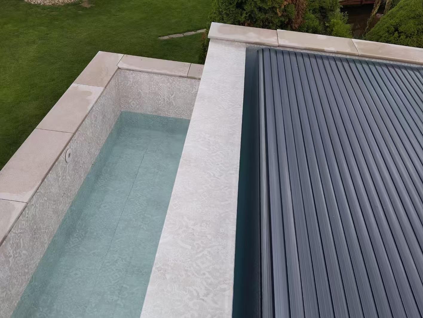 Pool With Gray Cover, Surrounded by Stone Coping and Grass — Port Douglas Pool Shop in Craiglie, QLD