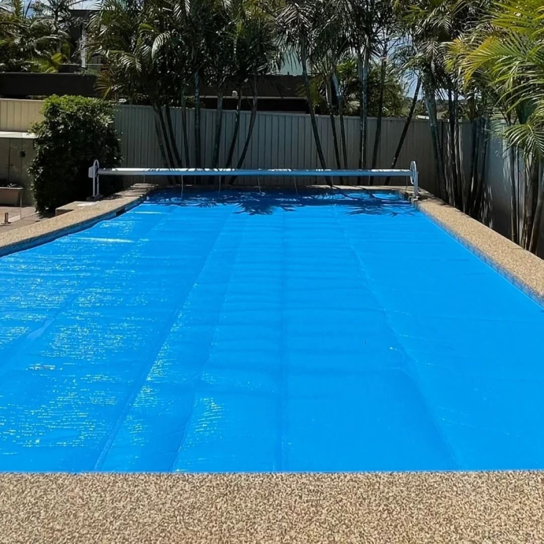 Blue Pool Cover on a Rectangular Pool, Surrounded by a Tan Border — Port Douglas Pool Shop in Craiglie, QLD