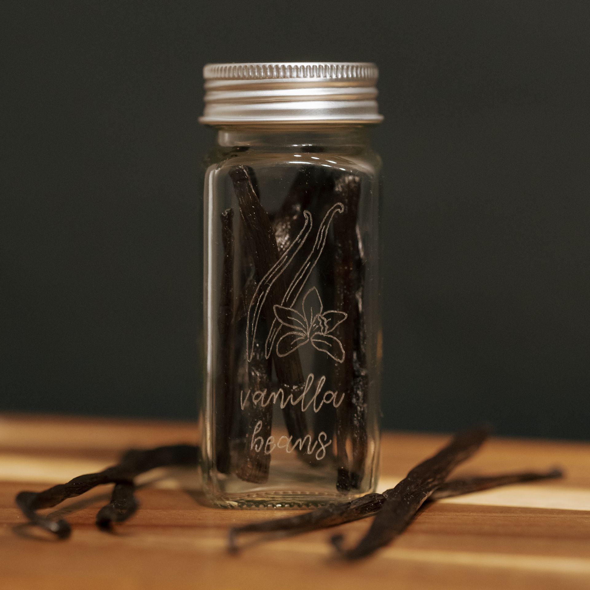 Glass jar of vanilla beans with 
