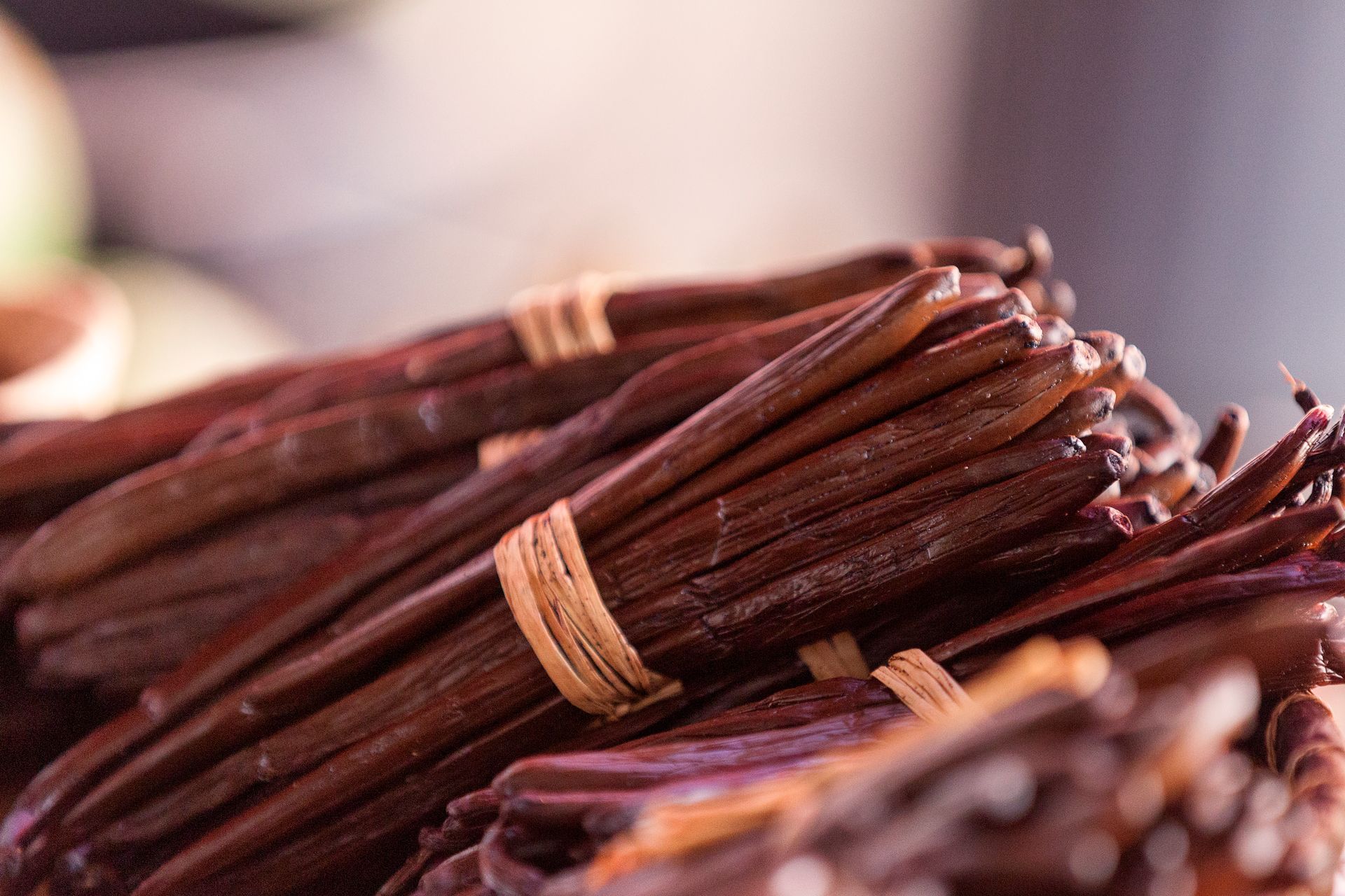 Bundles of dark brown vanilla beans tied together with twine.