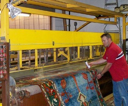Man Cleaning Rug — Madison, WI — Gulesserian’s Oriental Rug Sales & Service