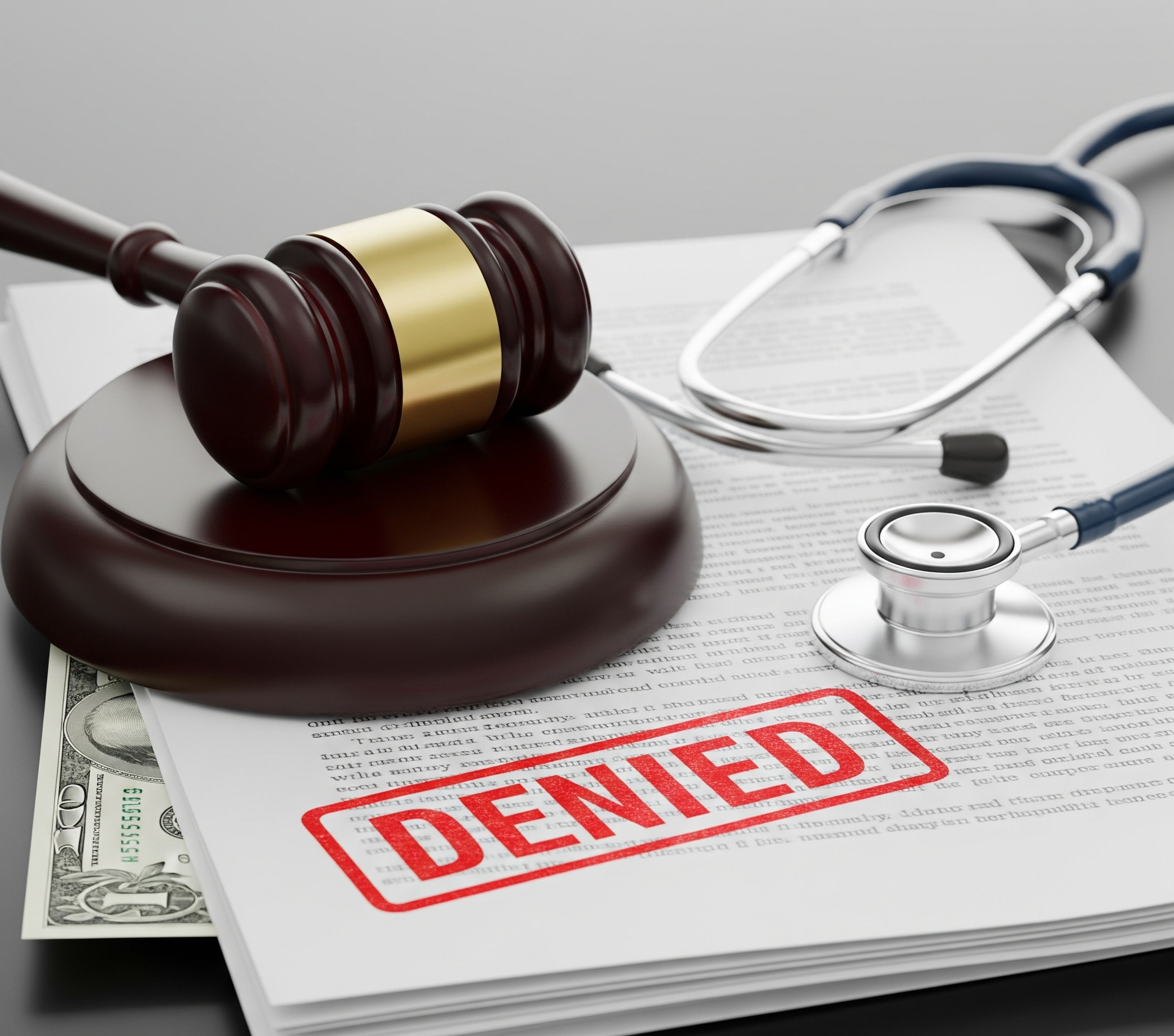 A judge's gavel and a stethoscope rest on legal documents stamped DENIED, symbolizing the process of