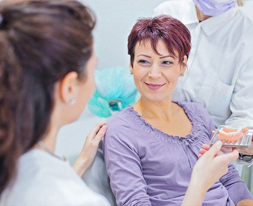 Woman being fitted for implant dentures at Union Dental