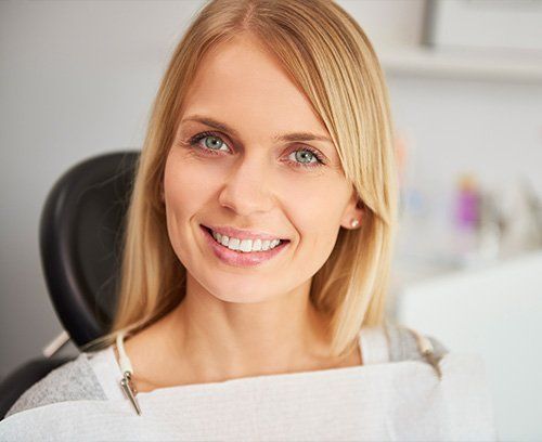 Young blonde woman smiling after recieving a teeth whitening procedure at Union Dental