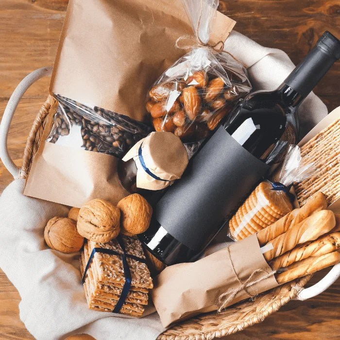 A basket filled with food and a bottle of wine