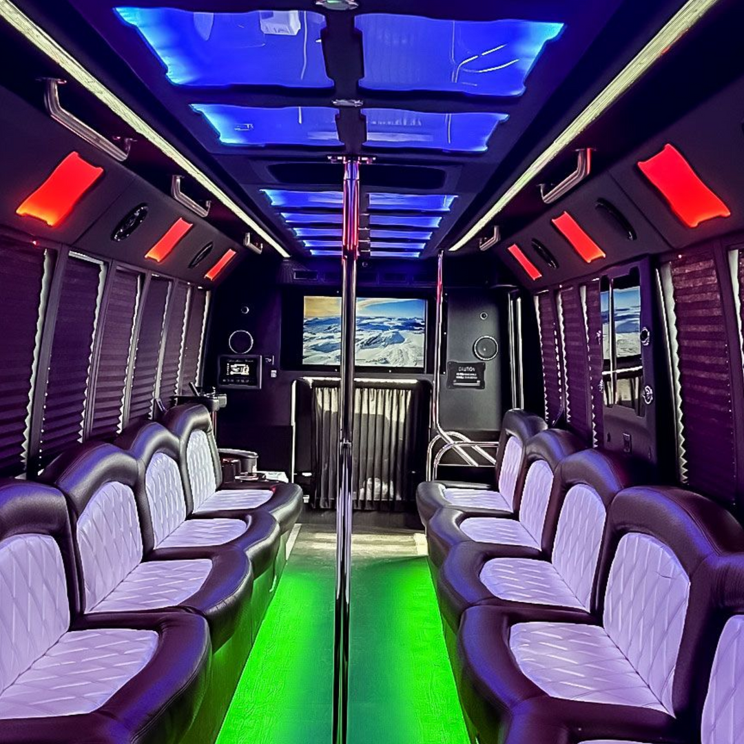 A white hummer limousine is parked on the side of the road at night