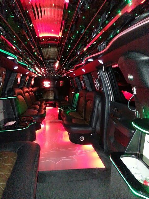 The inside of a limousine with lots of seats and lights.