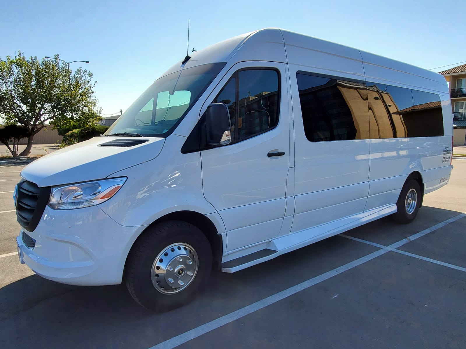 A white van is parked in a parking lot.