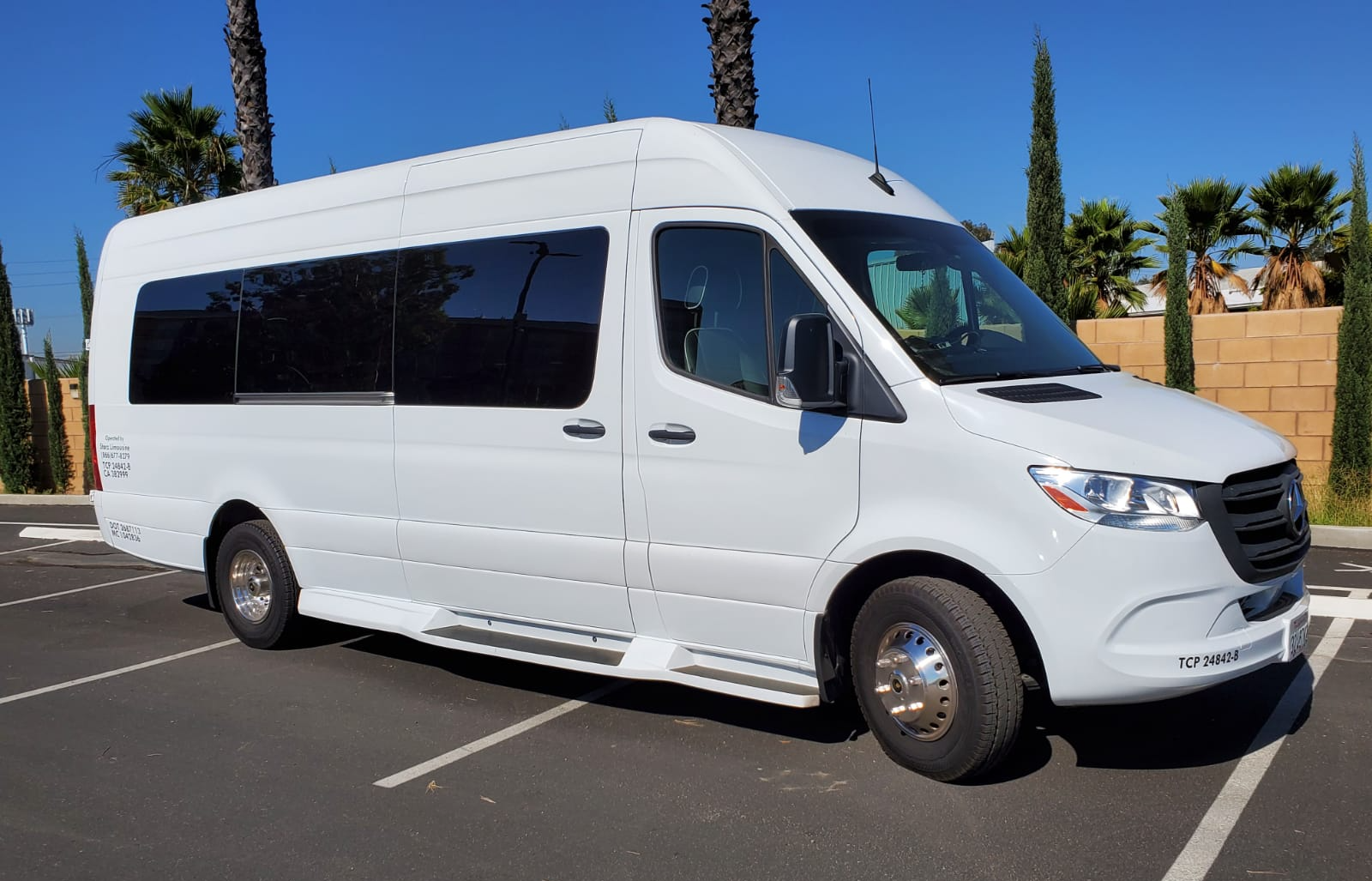 A white van is parked in a parking lot.