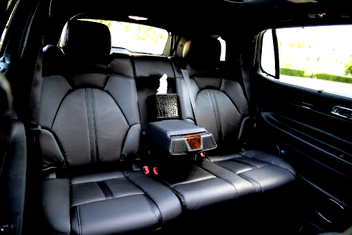 The back seat of a car with a tissue box in it.