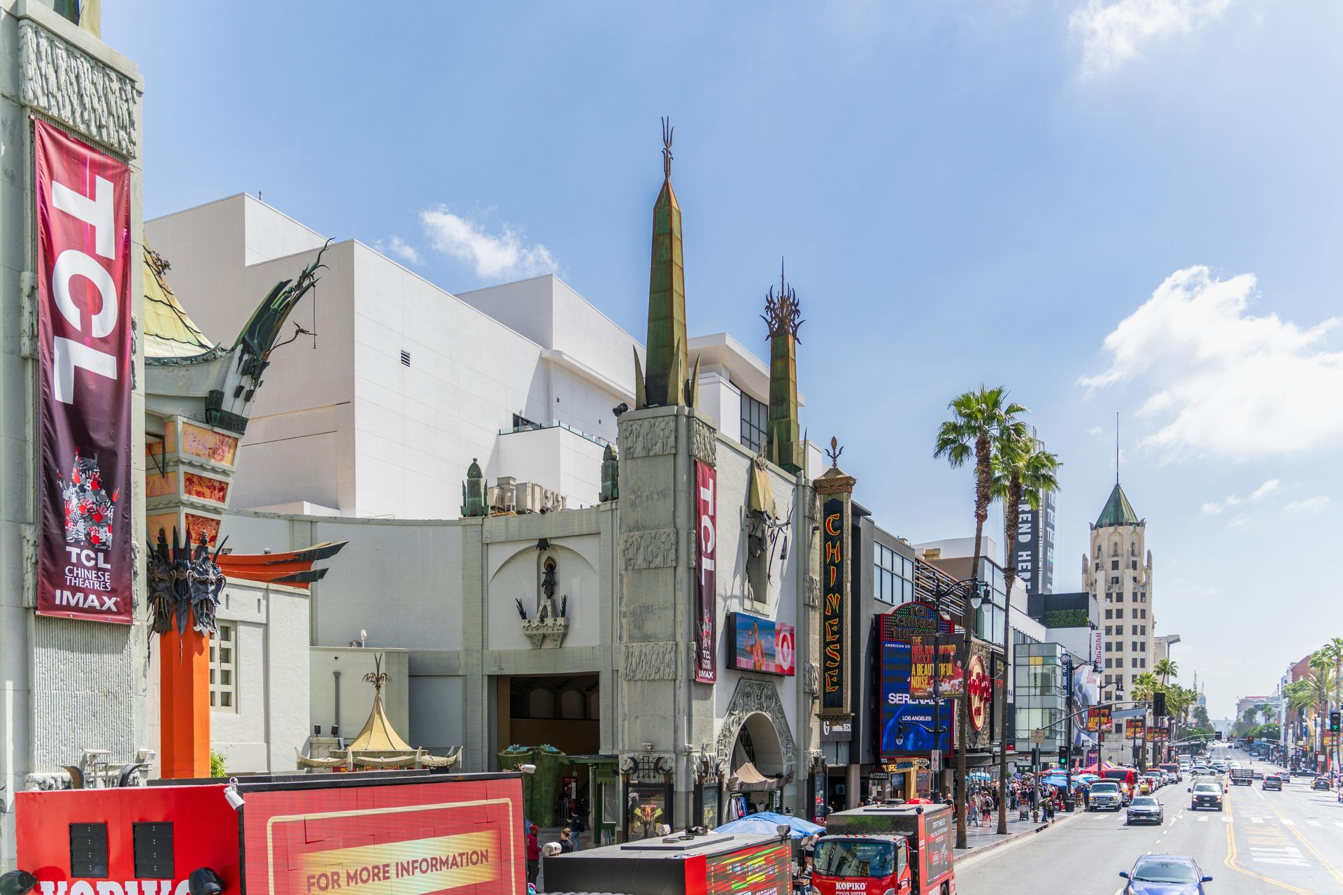 A street with palm trees on the side of it in a city.