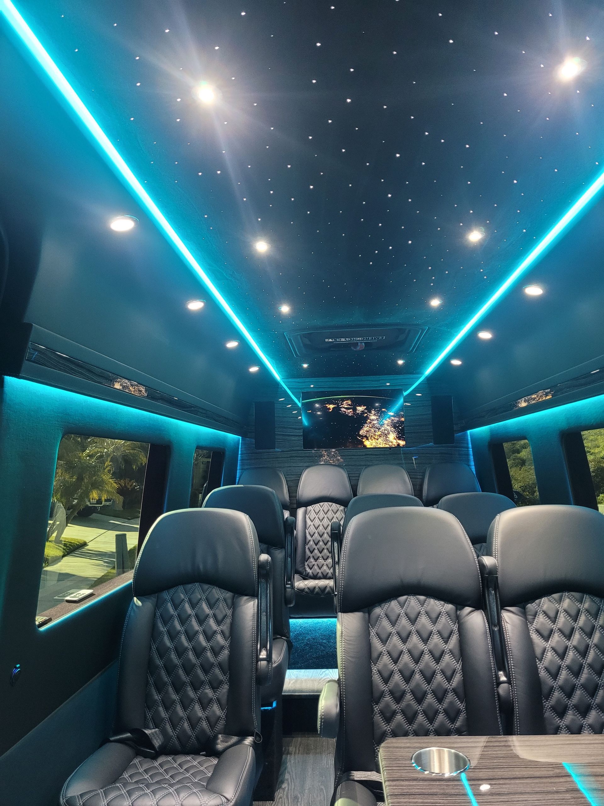 The inside of a van with blue lights on the ceiling.
