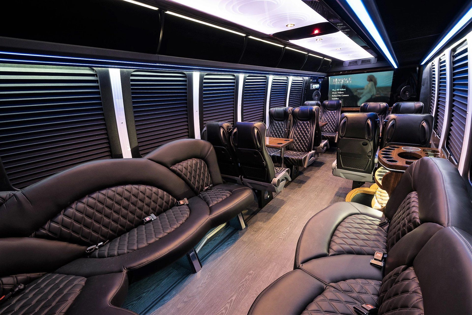 The inside of a limousine with lots of black leather seats