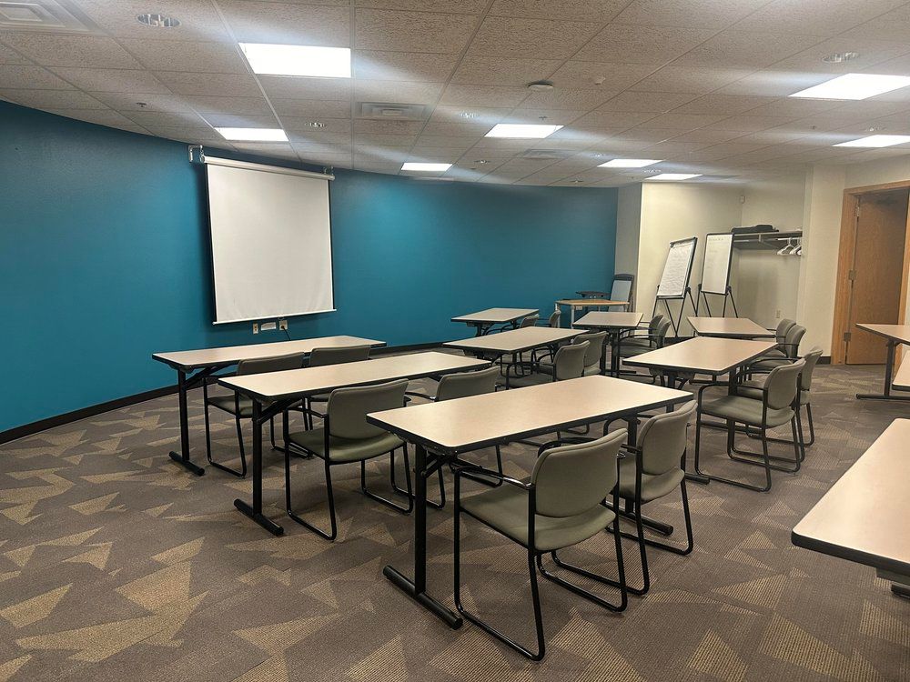 A Classroom with Tables and Chairs and a Projector Screen — Madison, WI — Beyond Words Productions LLC