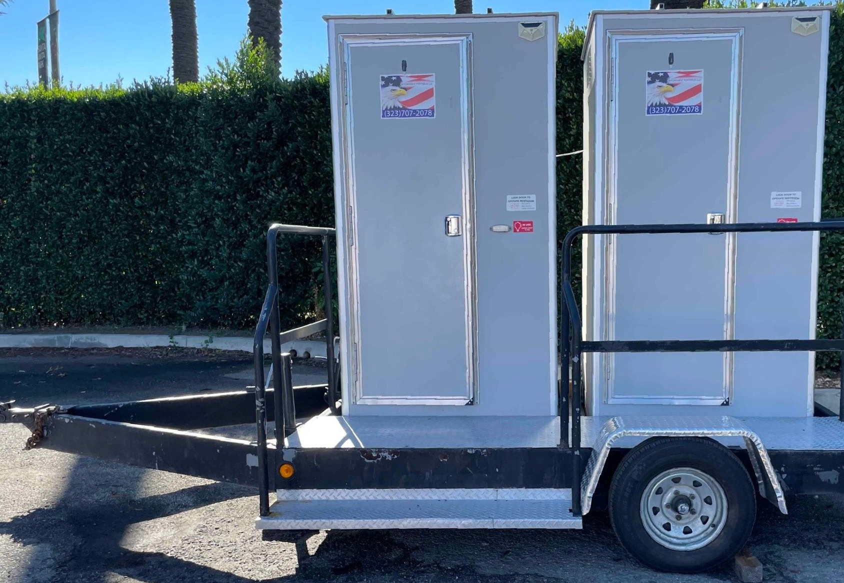 Portable restrooms lined up for an event in the parking lot. Portable restrooms lined up for an event in the parking lot.