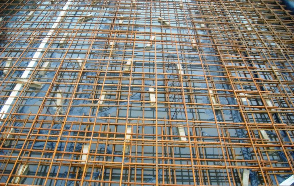 The reinforcement, typically, fabric sheets, is laid on concrete spacers , tied and checked prior to the pour.