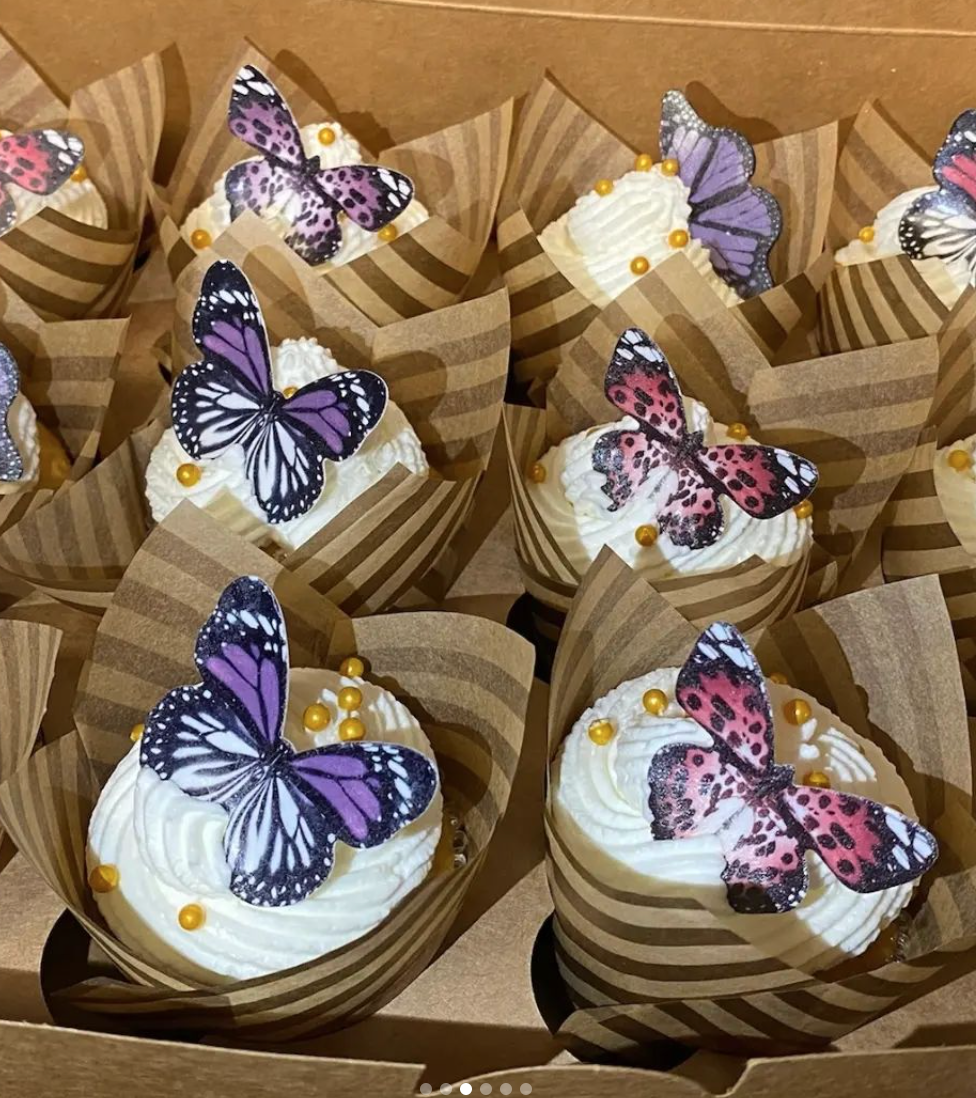 A box of cupcakes with butterflies on them