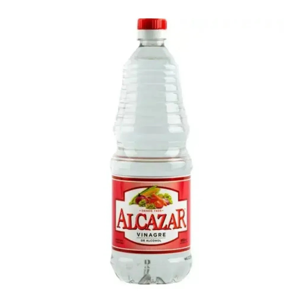 Una botella de vinagre de alcázar con tapón rojo