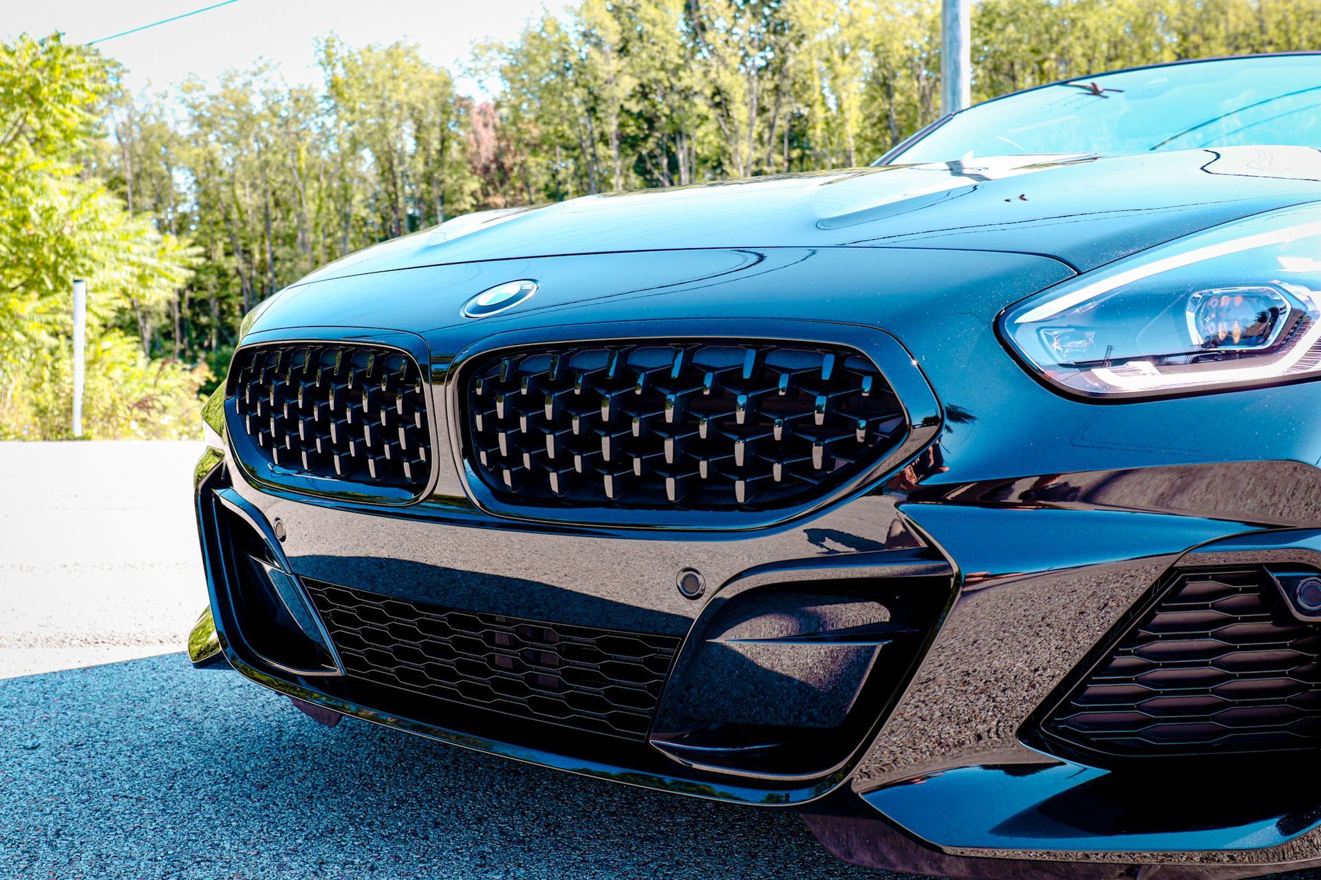 a black suv is parked on the side of the road .