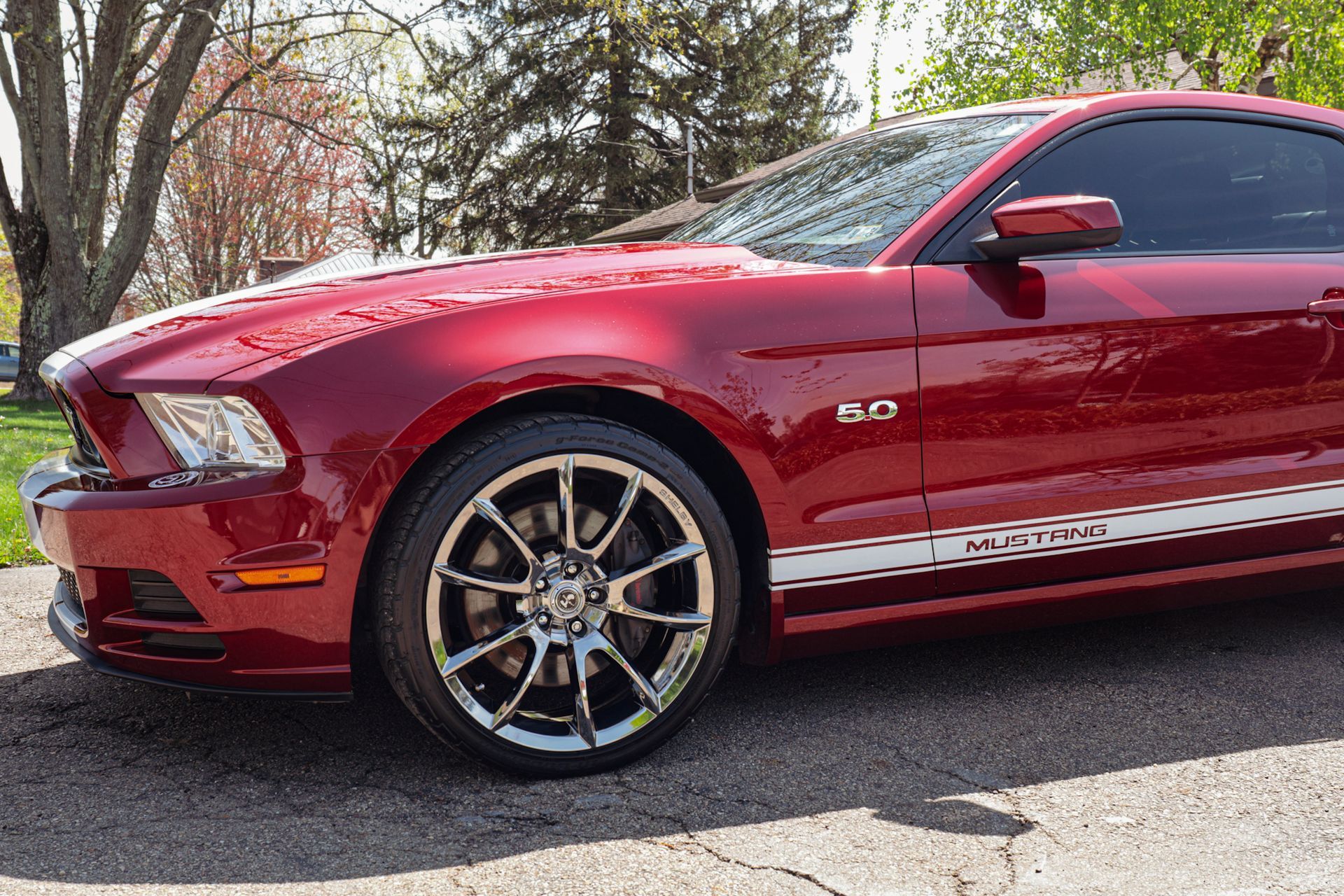 a blue gmc truck is parked on the side of the road .