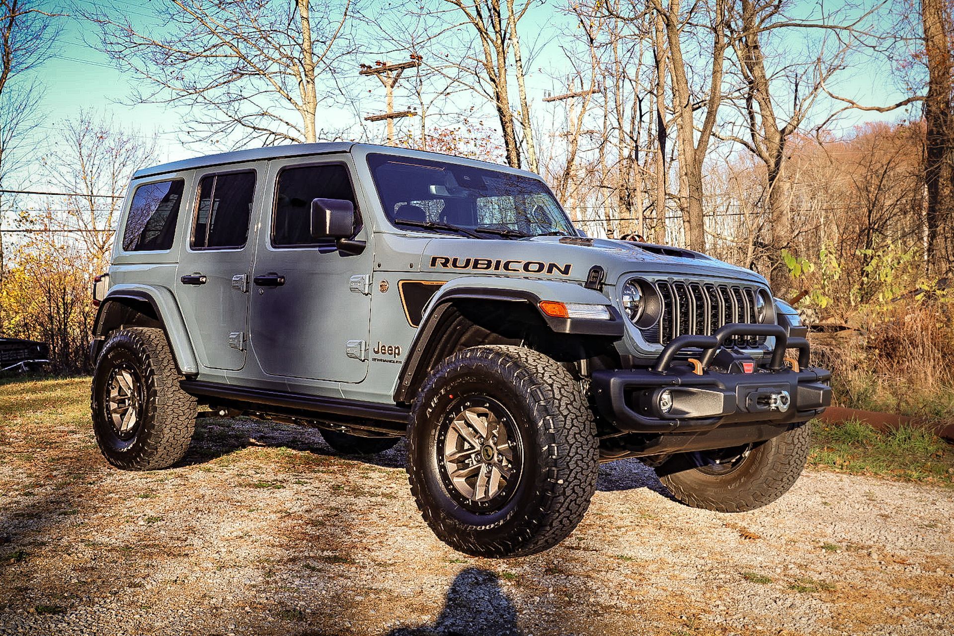 a man is polishing a black truck in a garage .