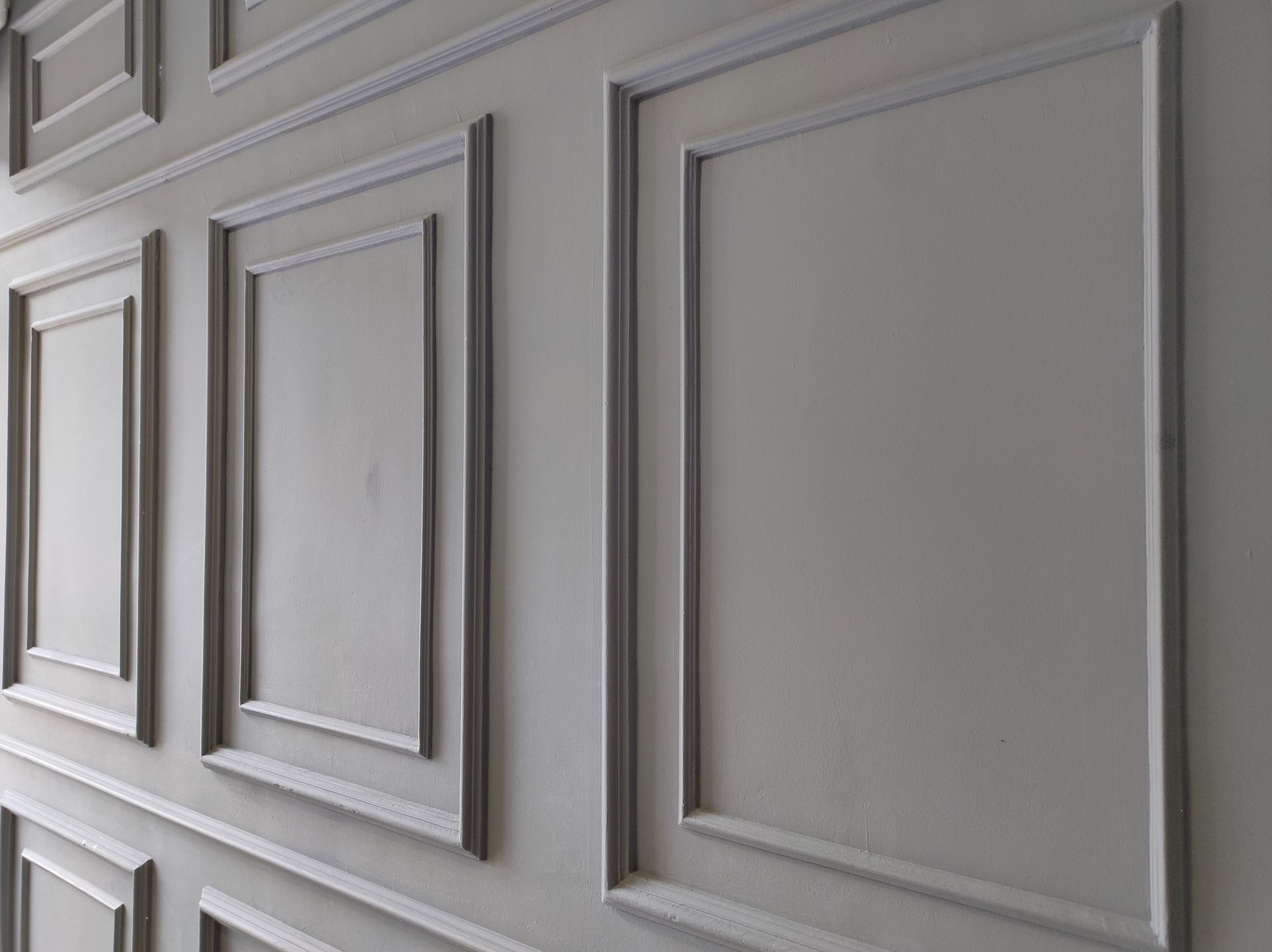 Gray wall with rectangular panel molding.