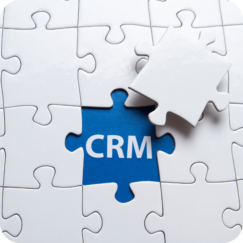 A white puzzle with a blue piece that says crm