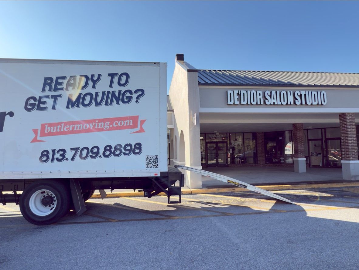 A moving truck is parked in front of a house.