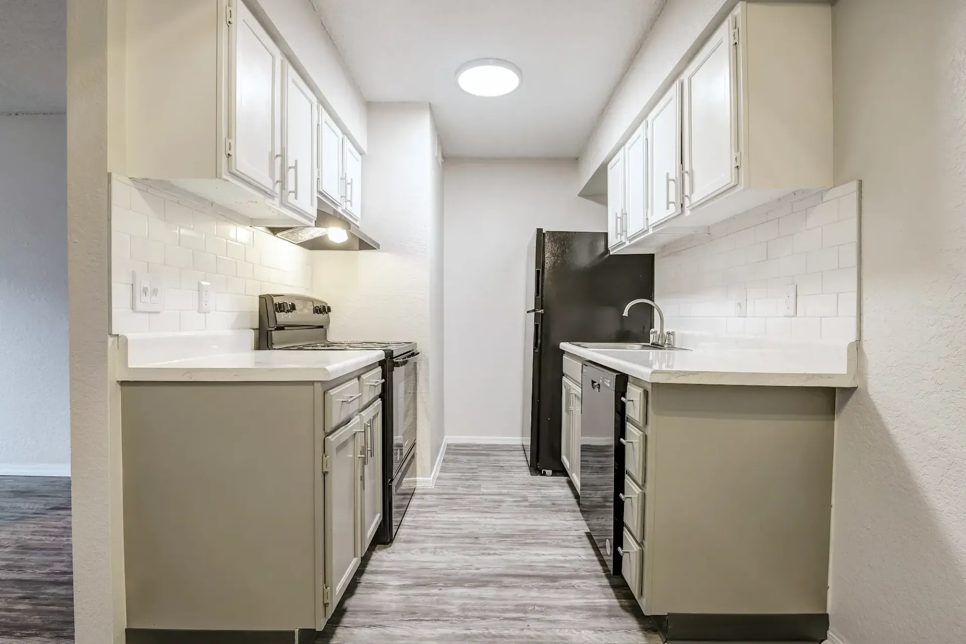 An empty bedroom with a walk in closet and a carpeted floor.