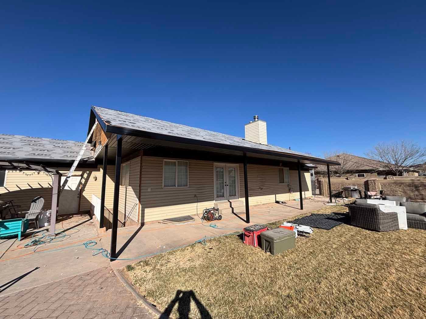 A house with a covered patio in front of it.