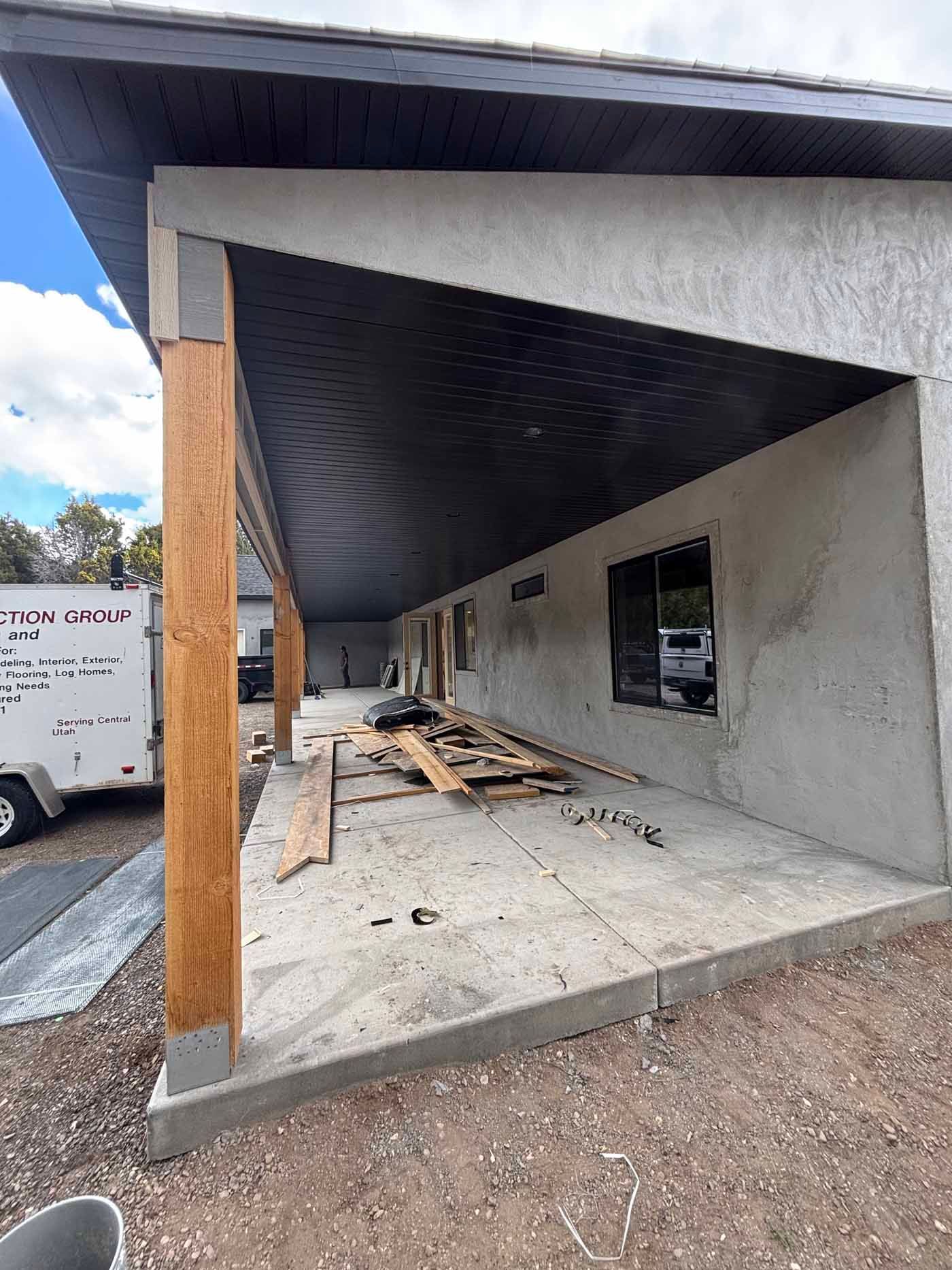 A covered porch is being built on the side of a building.