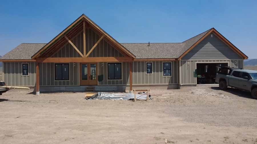 A large house with a truck parked in front of it.