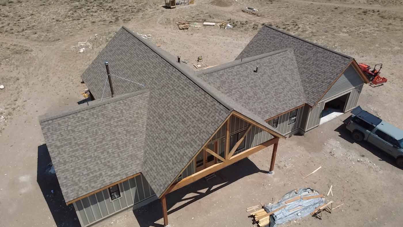 An aerial view of a house under construction with a car parked in front of it.