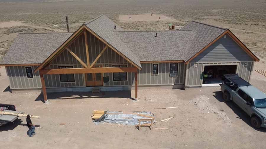An aerial view of a house under construction with a truck parked in front of it.
