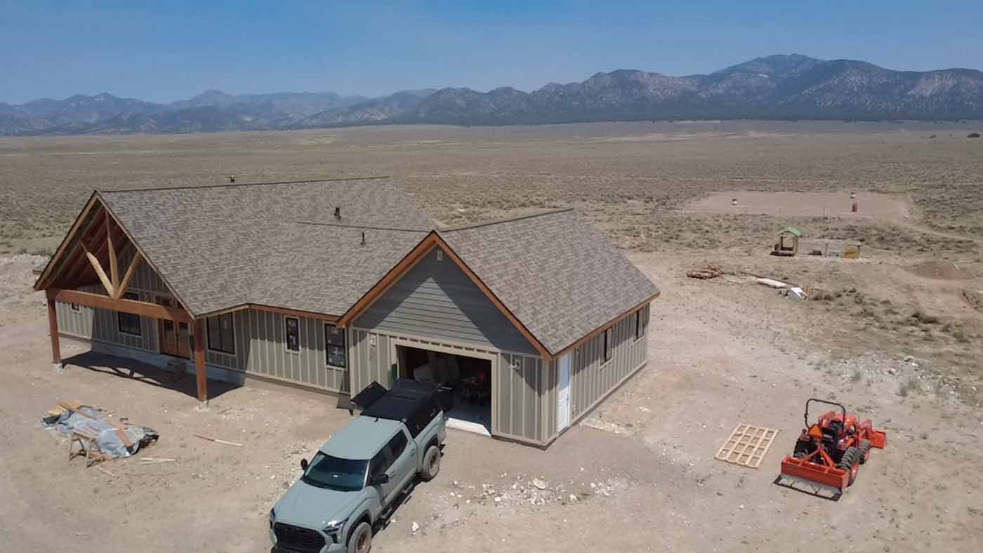 An aerial view of a house under construction in the middle of a desert.