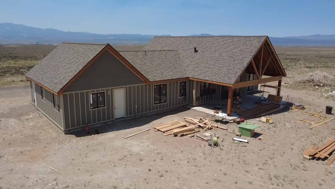 An aerial view of a house under construction in the desert.