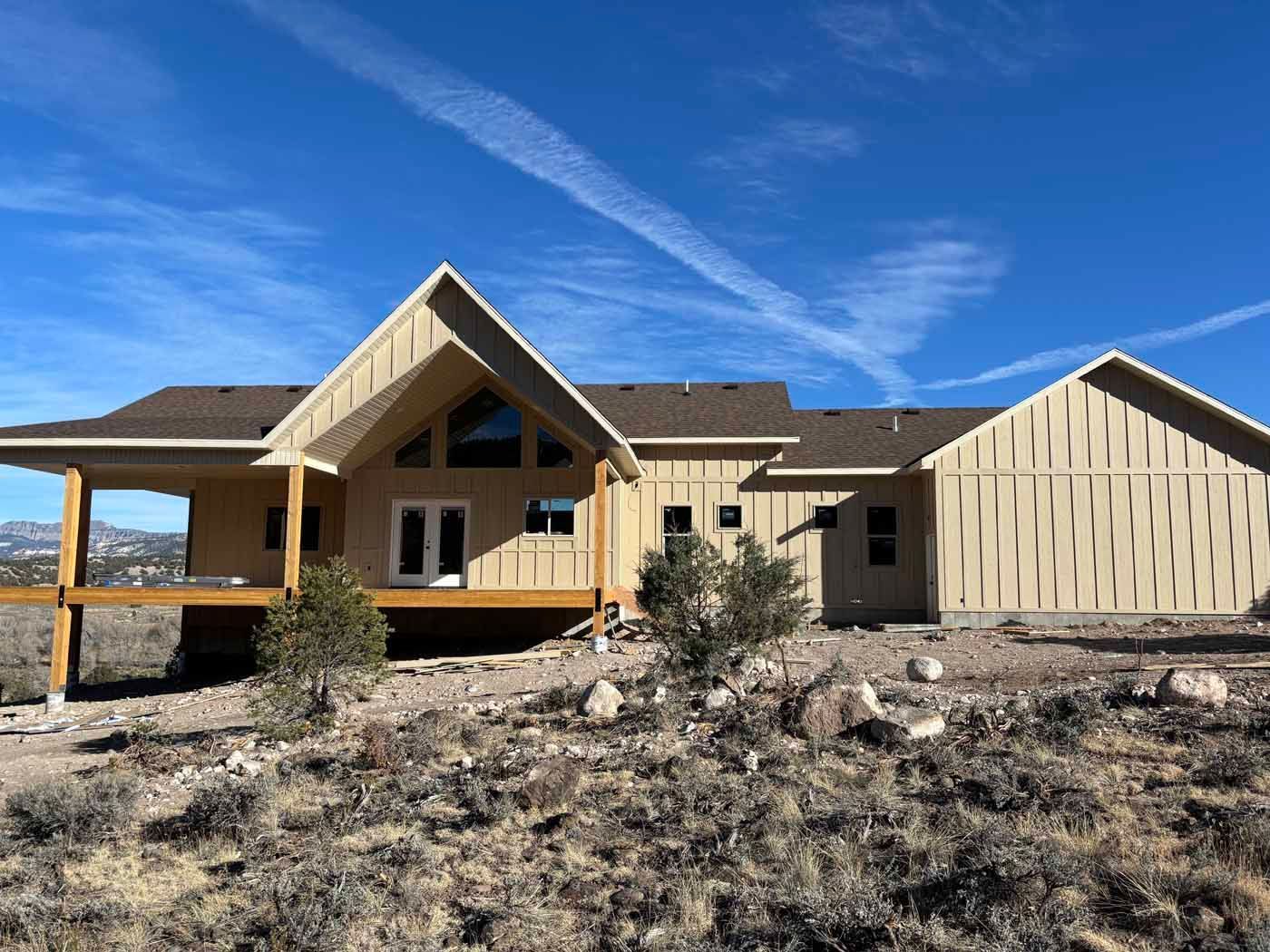 A large house is sitting in the middle of a desert.
