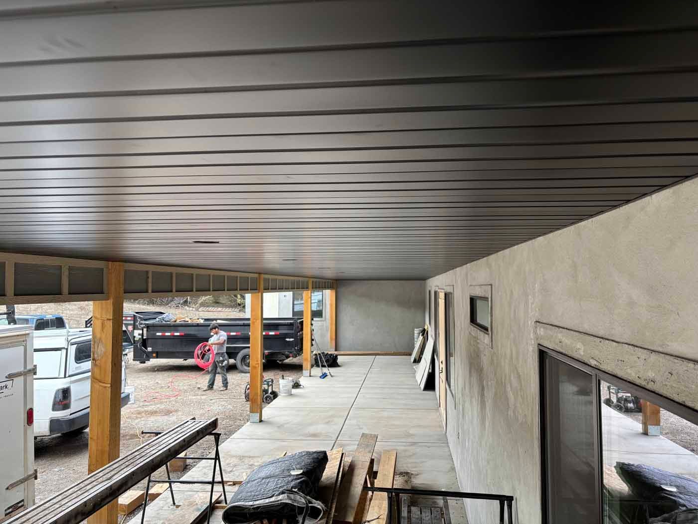 The ceiling of a building under construction with a truck parked in the background.