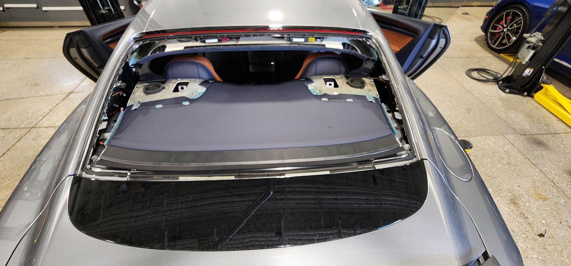 A car with open doors, revealing the interior. The back window is removed.