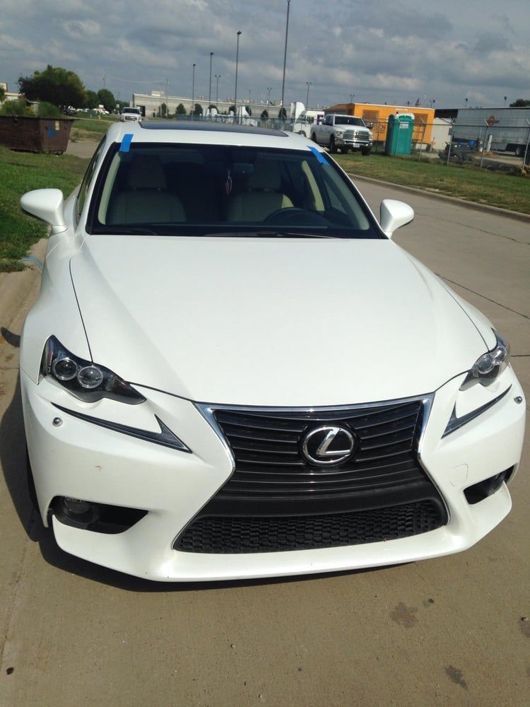 White Lexus sedan parked outdoors on a sunny day.