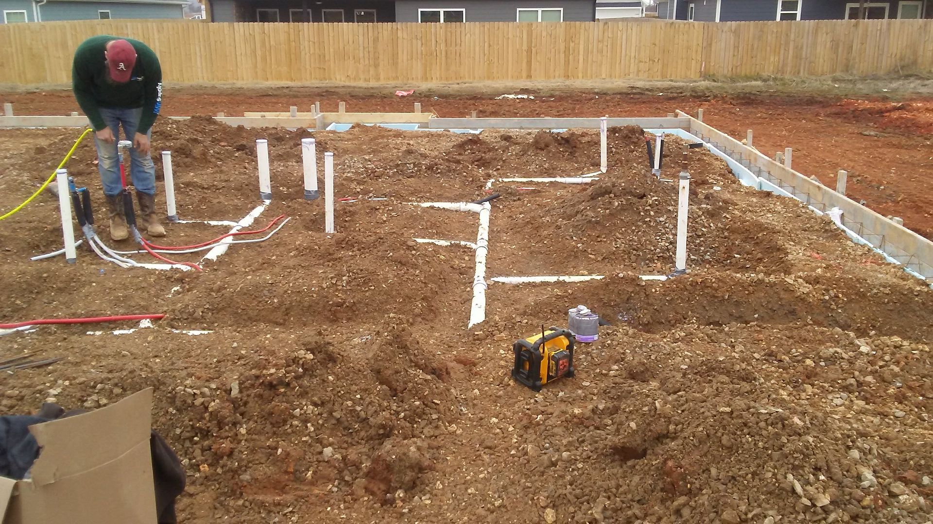 A man is working in the dirt on a construction site.