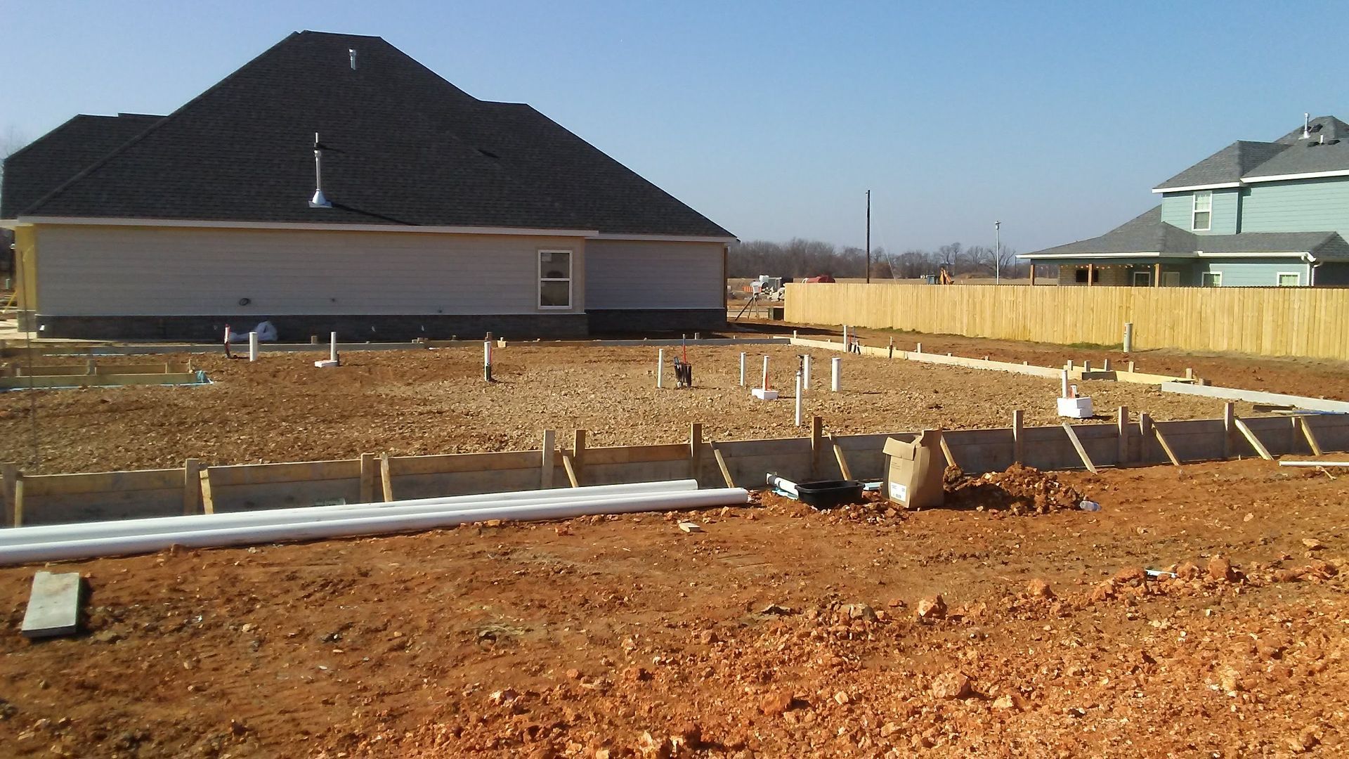 A house is being built on a dirt lot