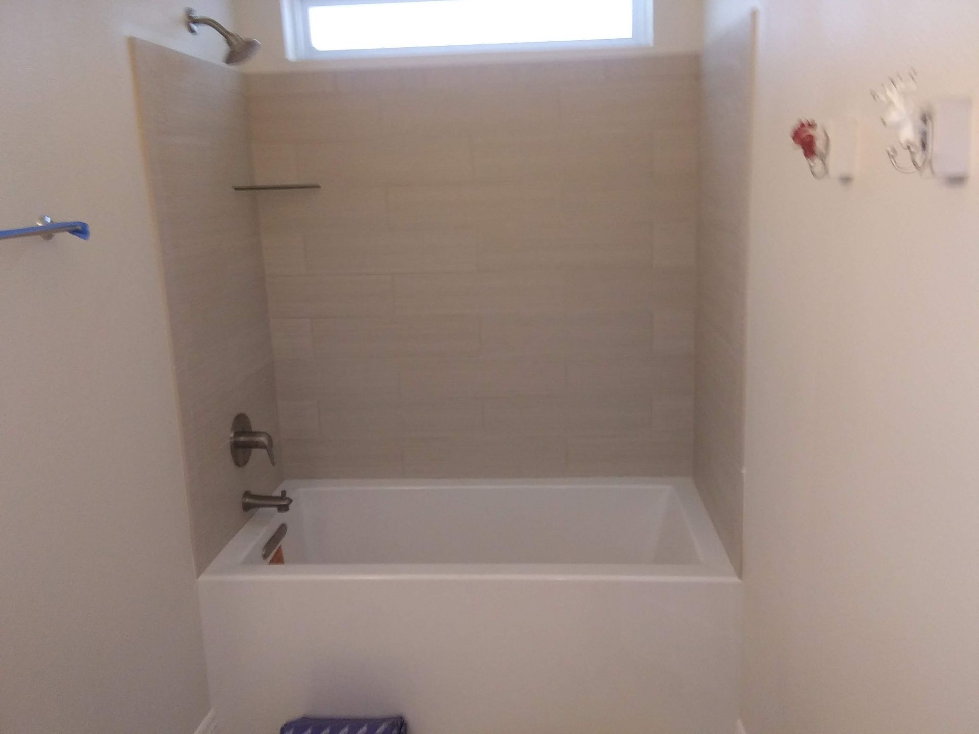 A bathroom with a bathtub and a shower.