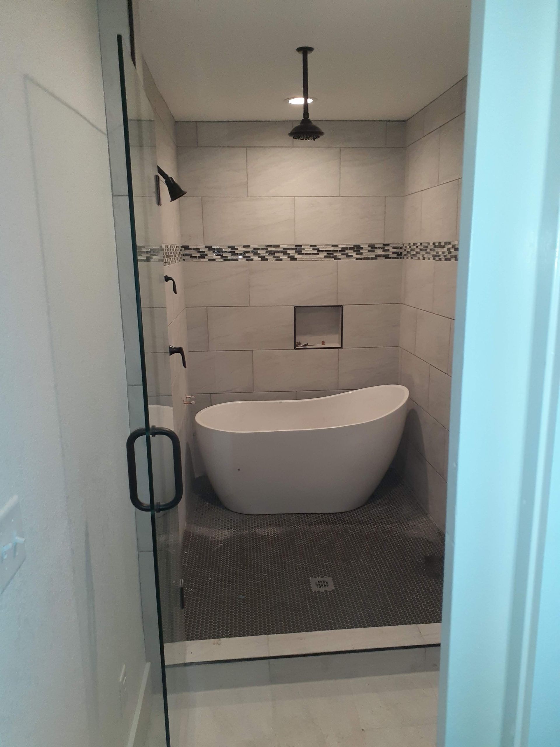 A bathroom with a bathtub and a walk in shower.