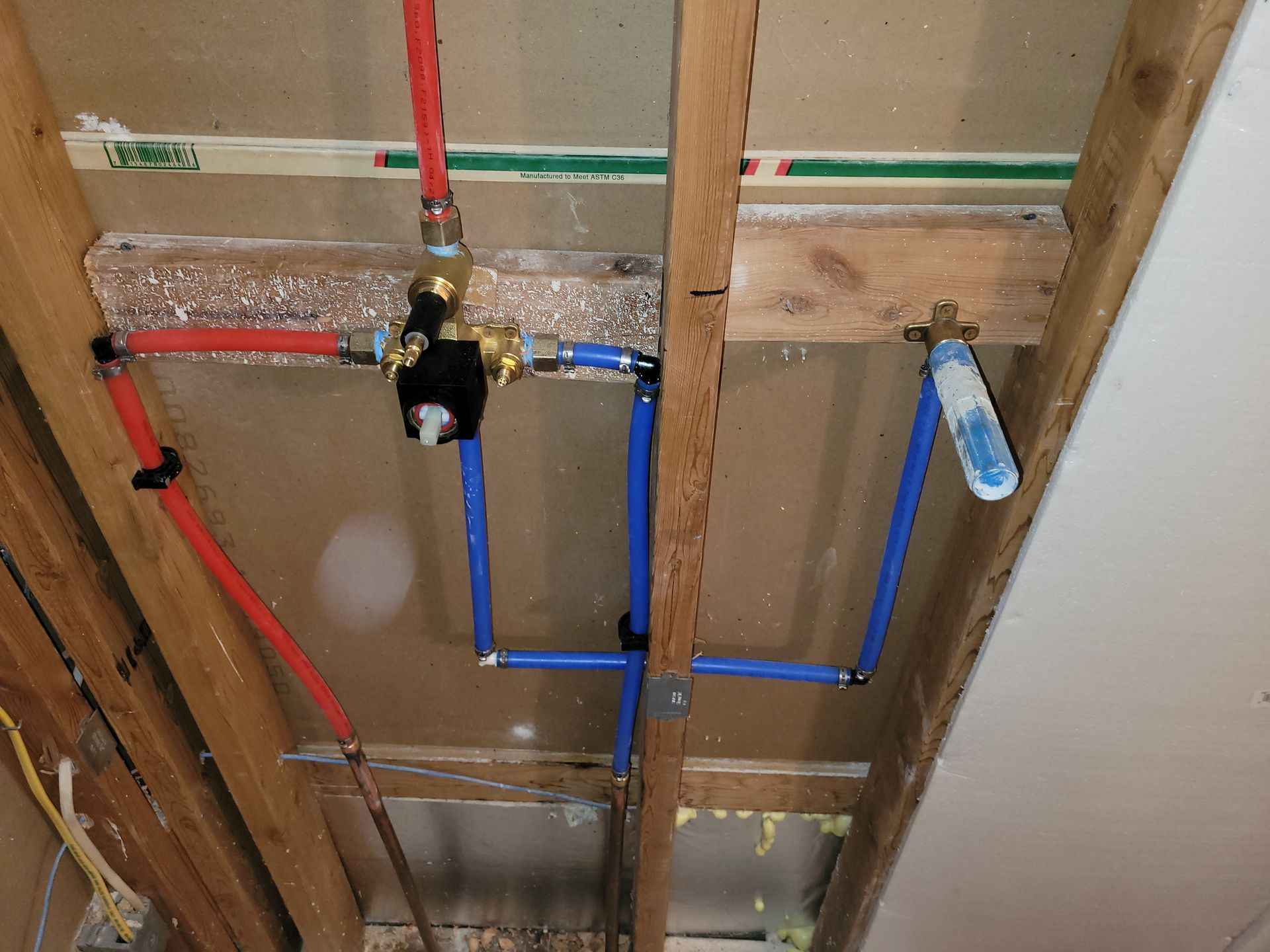 A bunch of pipes are hanging from the ceiling in a room.