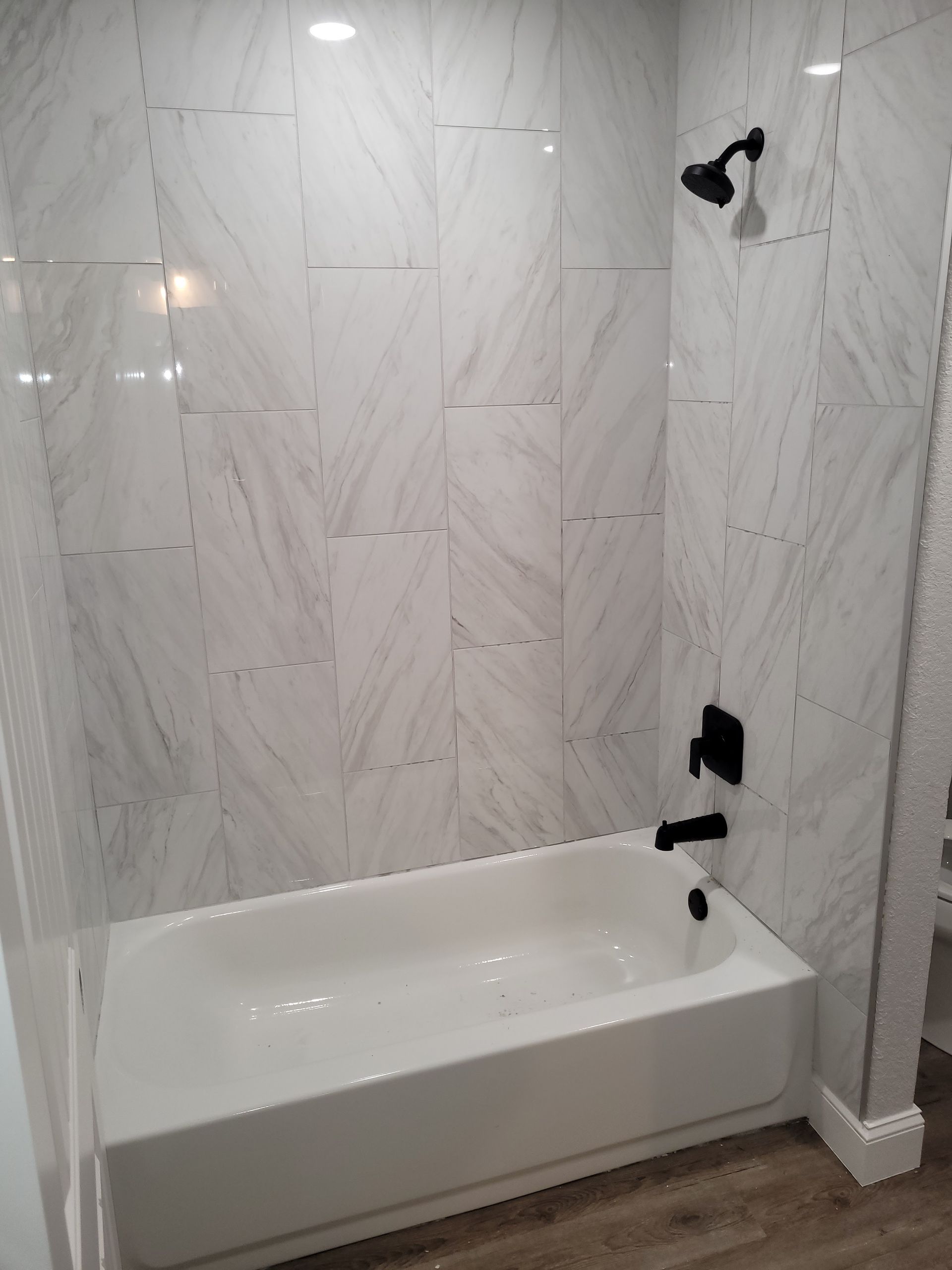 A bathroom with a bathtub and a shower.