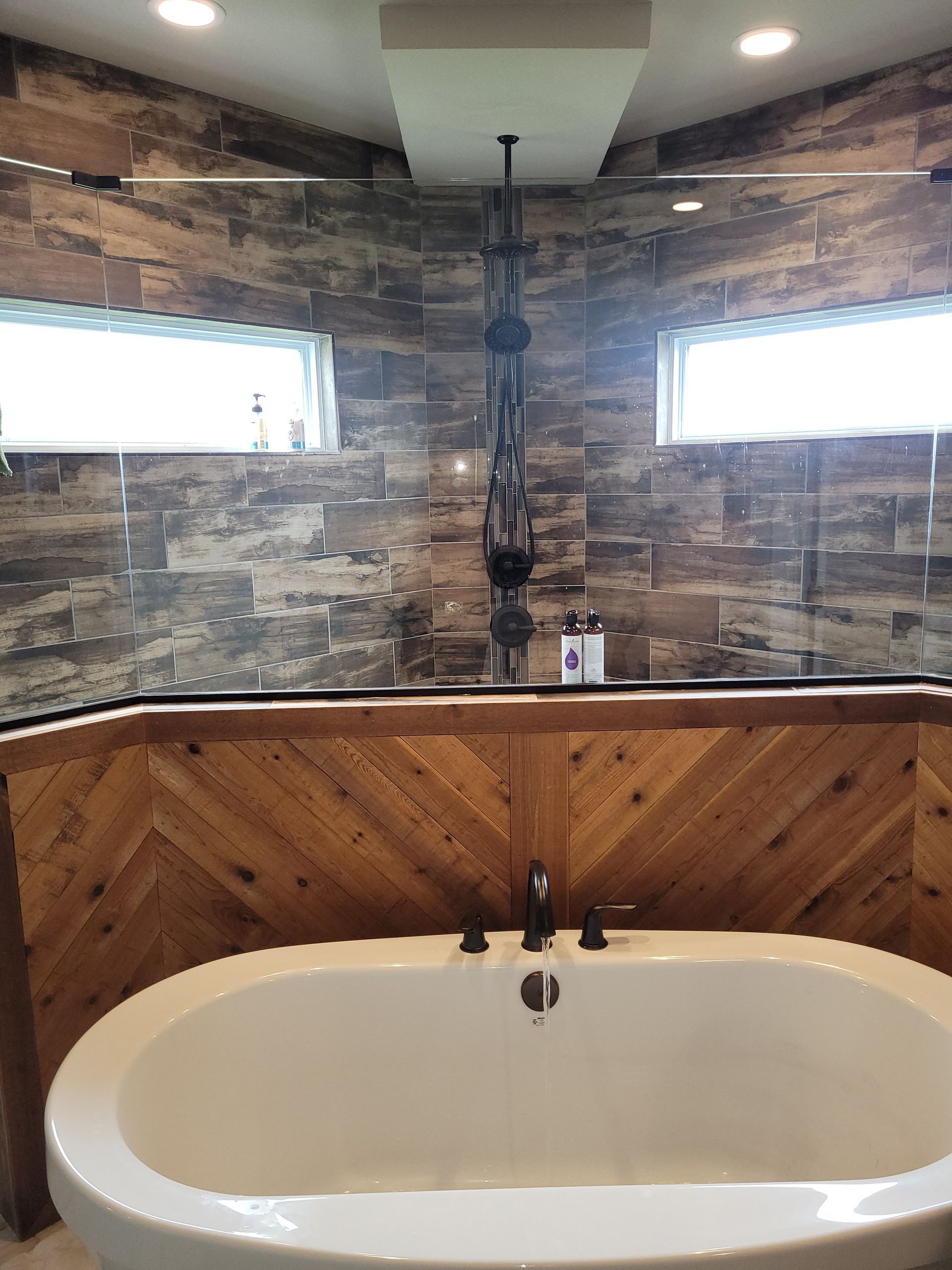 A bathroom with a bathtub and a walk in shower.